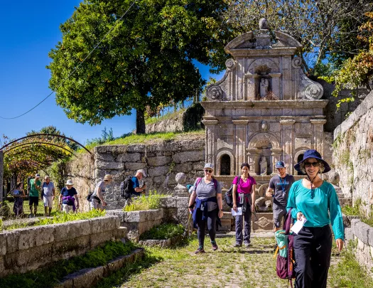 Guests walking among hilly stone ruins.