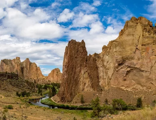 Large, jagged mountains and cliffs in a large gravel valley