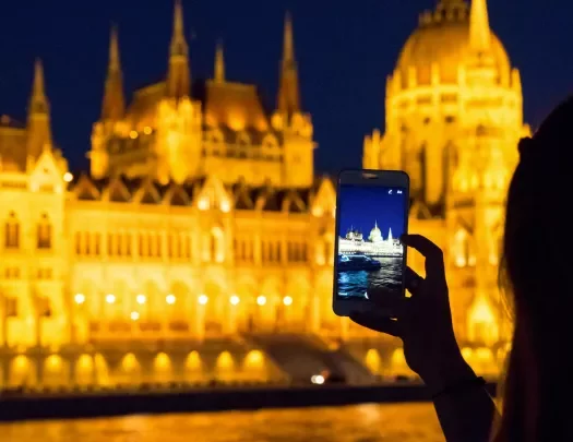 Person taking photo of an illuminated building