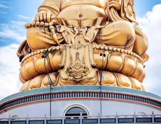 Large gold Buddha statue on top of building