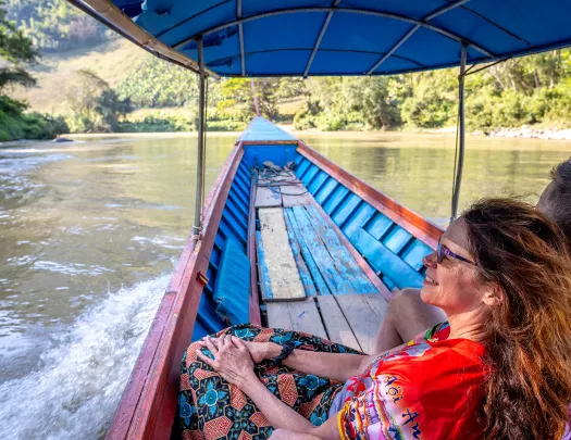 Two people at the head of a boat on a river