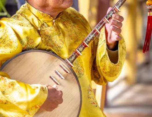 Person in yellow uniform playing instrument