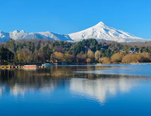 Snow capped mountain in the background of a lake