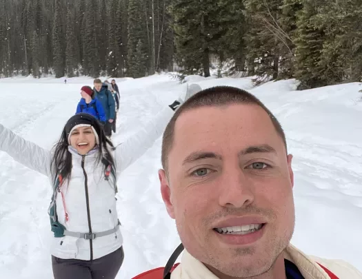 Two people take a selfie while snowshoeing in the snow