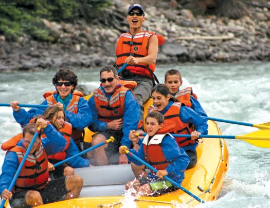 A group of people white water rafting