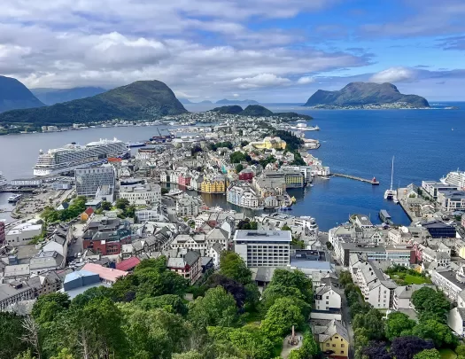 White buildings scattered across a town, surrounded by the ocean