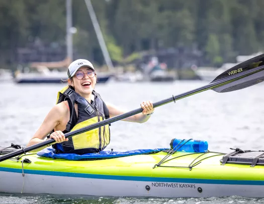 Woman paddling on a kayak in a lake