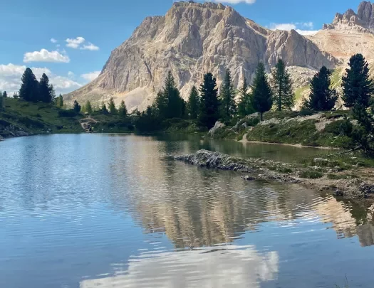 Dolomites reflected in a calm and clear lake