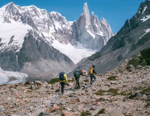 hikers walking against snowey mountains