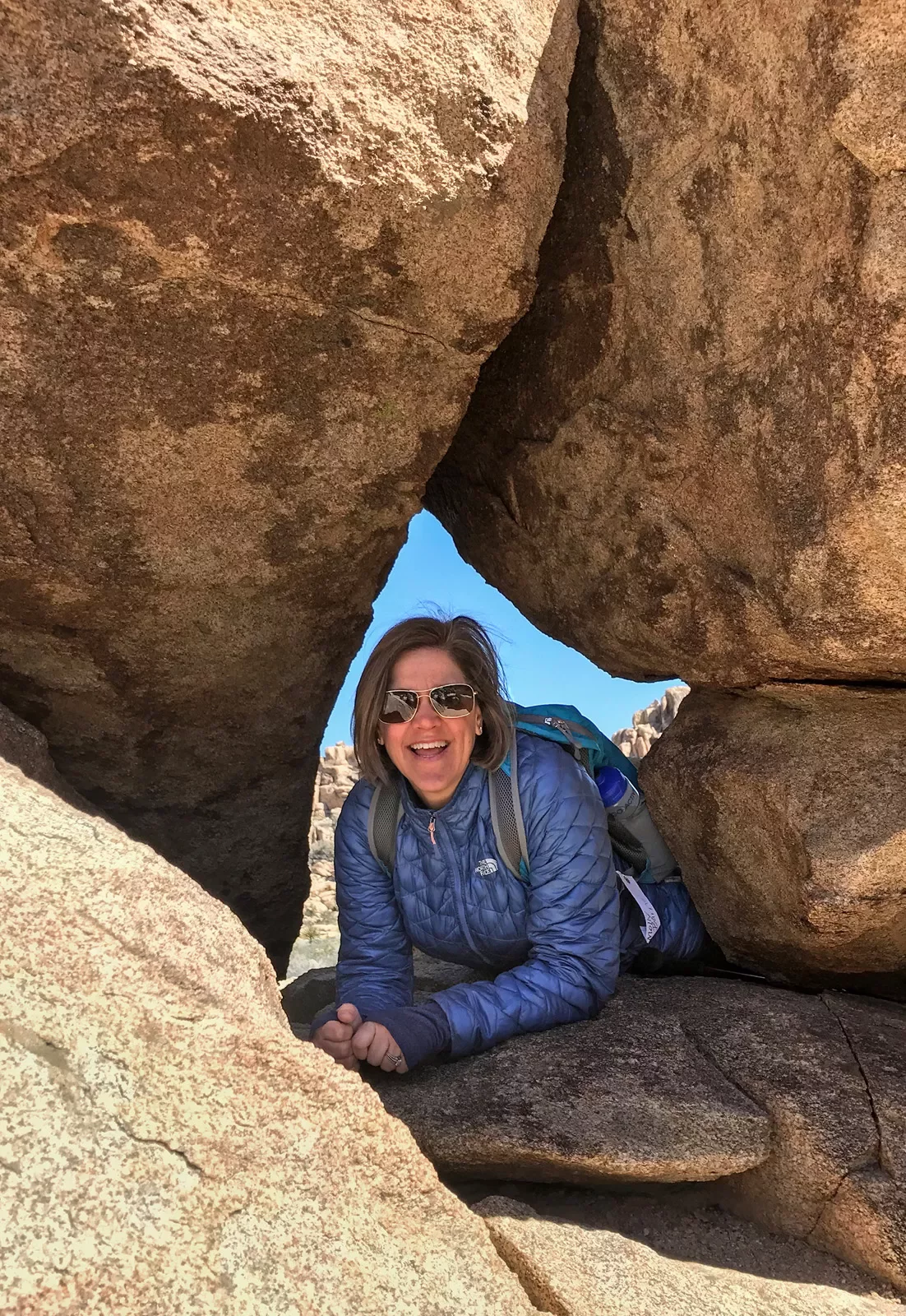 Woman smiling in a rock crevasse