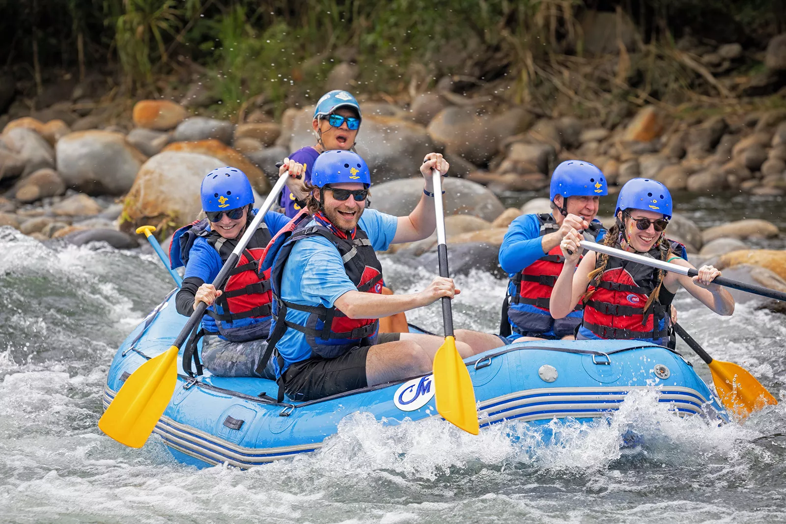 Guests and leader white-water rafting.