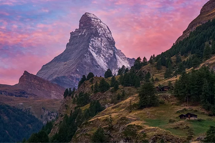 pink sunset behind a mountain