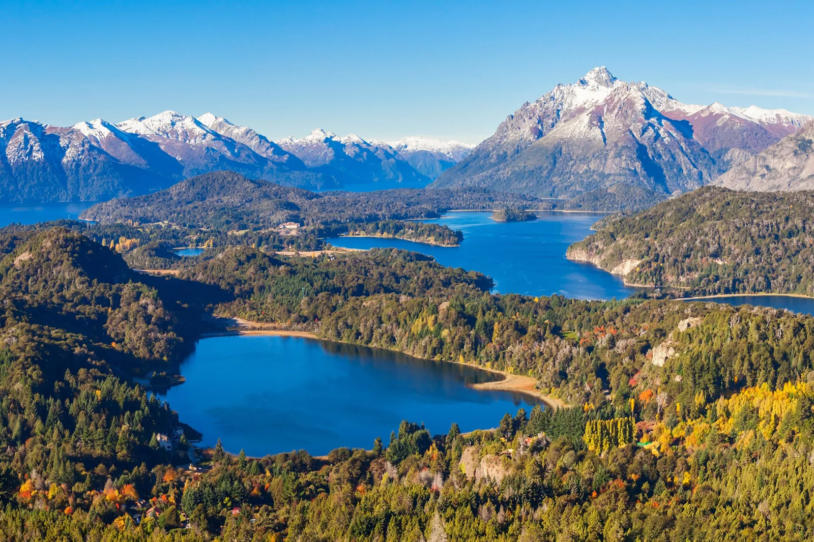 Multiple lakes surrounded by tall trees and mountains