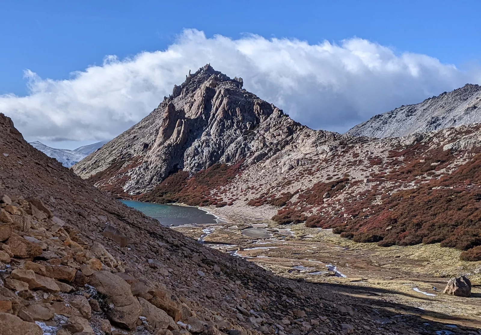 Gray and red mountains with foggy clouds in the sky