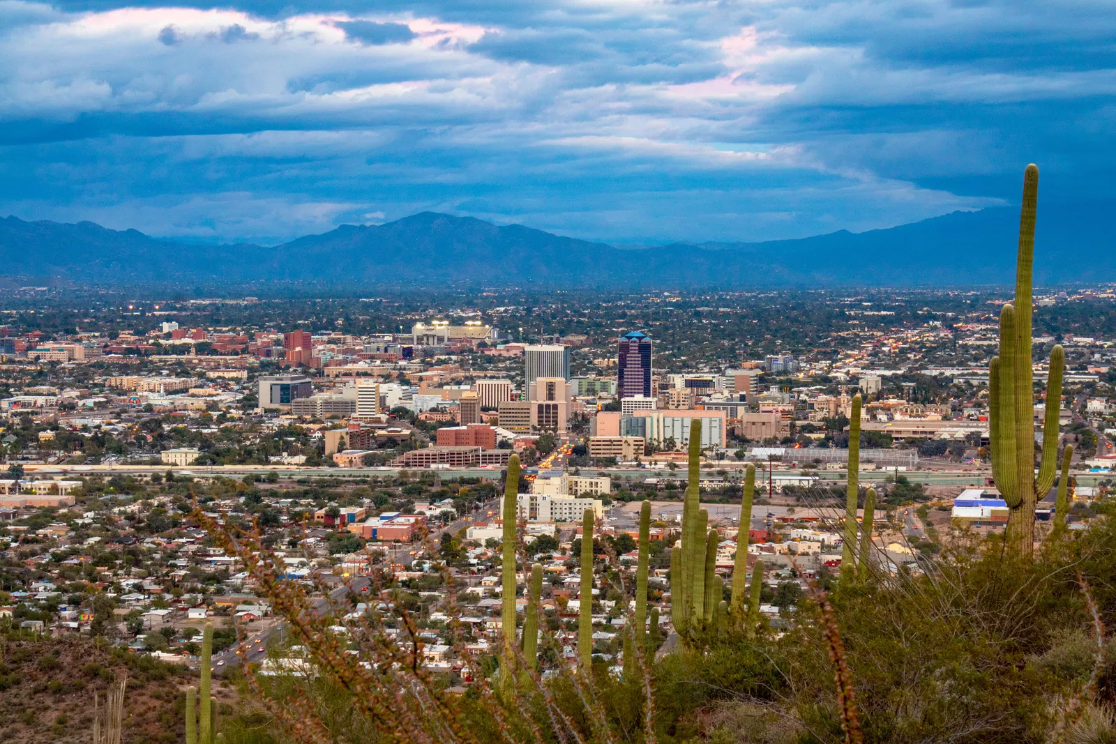 Sky view overlooking a city with large mountains in the distance