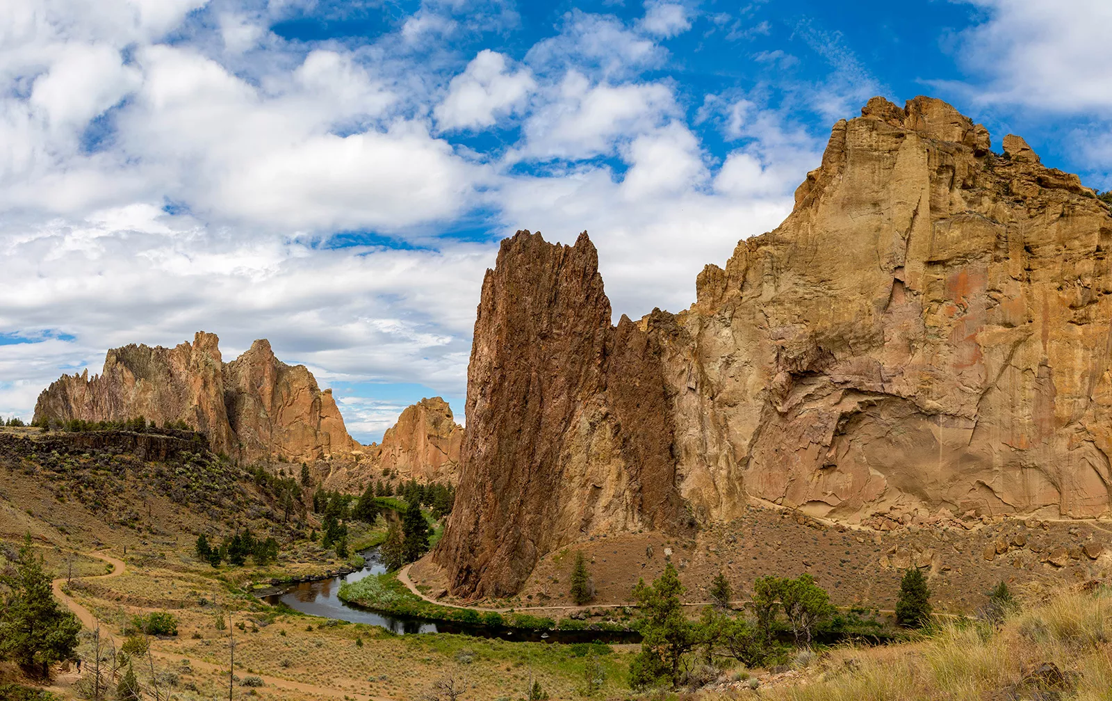 Large, jagged mountains and cliffs in a large gravel valley