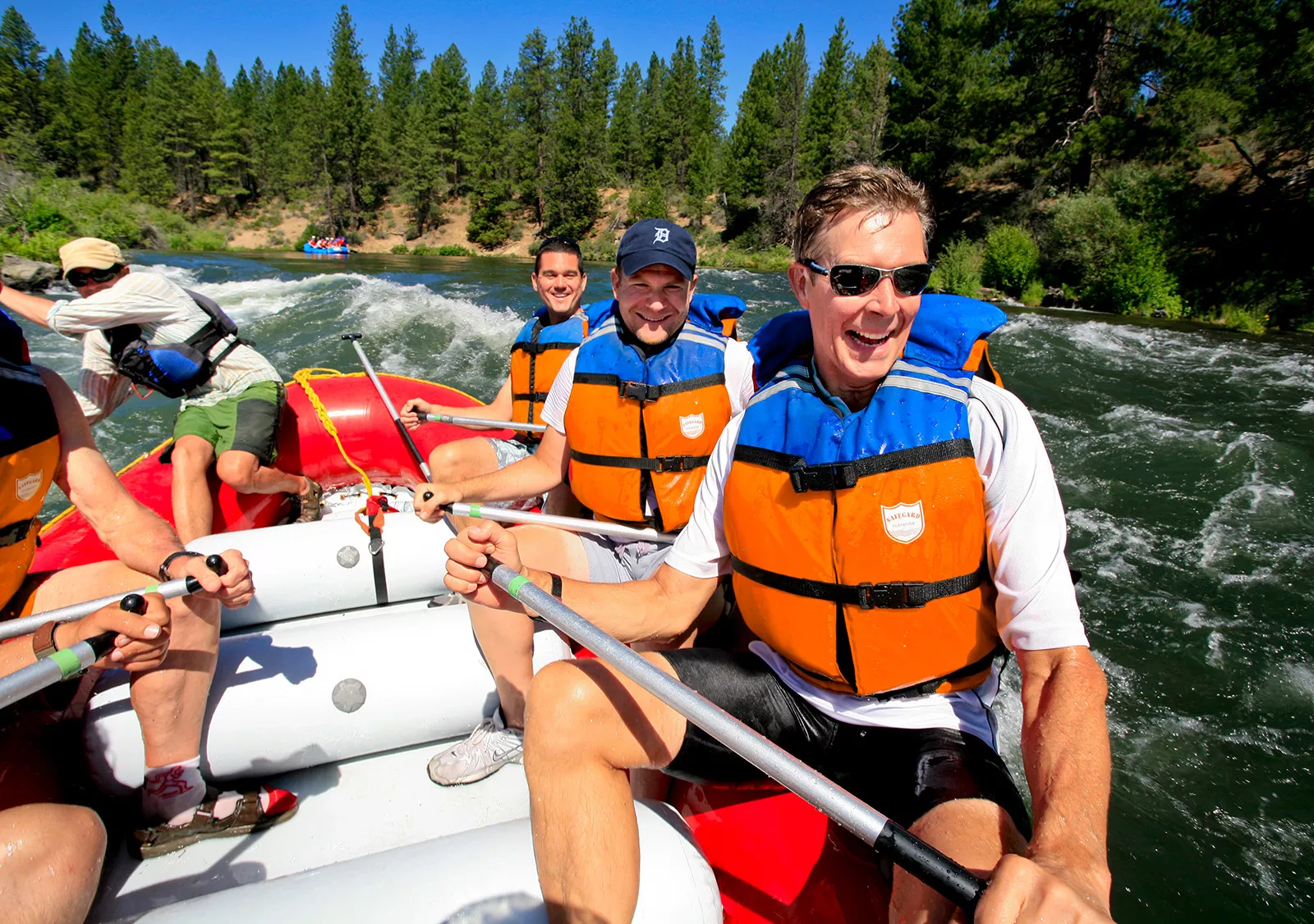 Group of people on a raft while paddling in a river