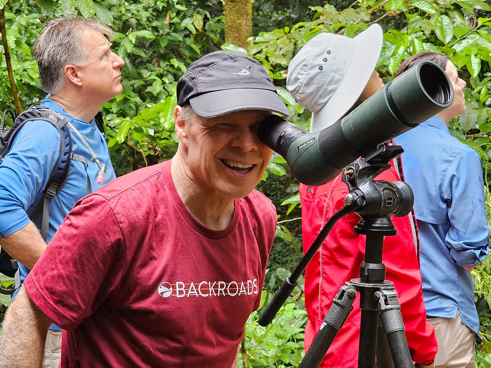 Man looking into a small telescope