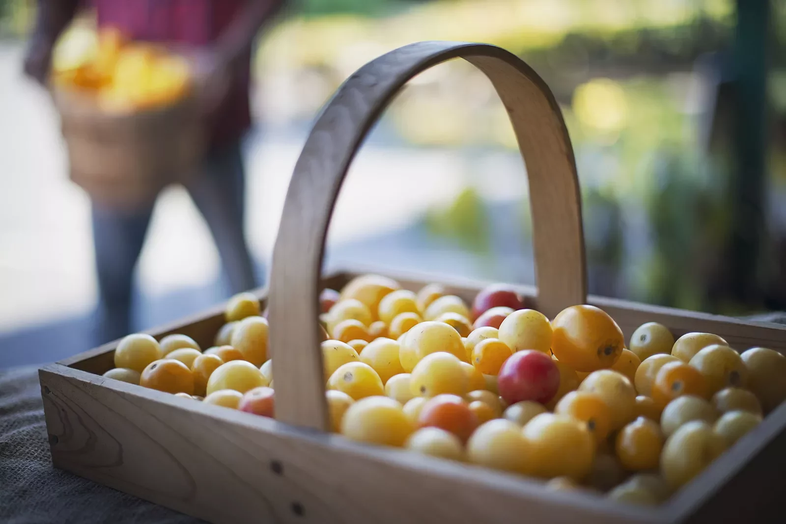 Wooden basket full of yellow fruits