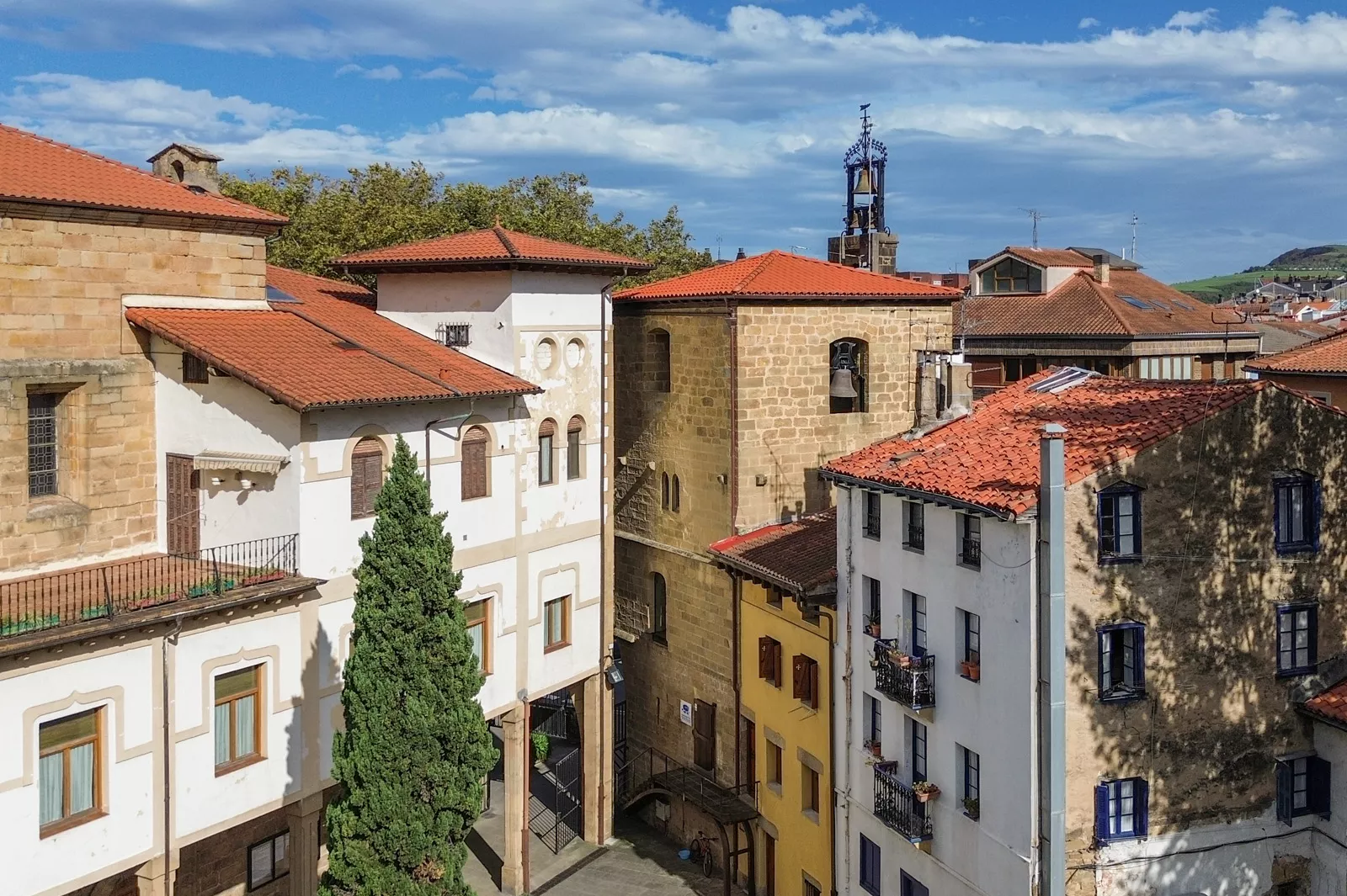 Sky view of 3-story apartment buildings in a small, rustic town