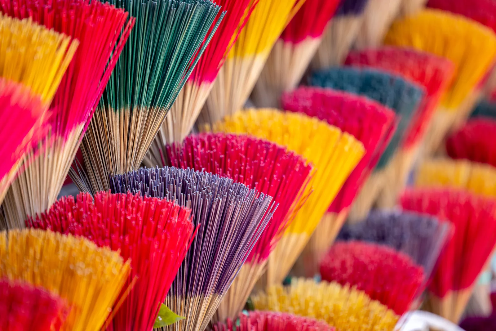 Vendor stall full of colorful incense sticks