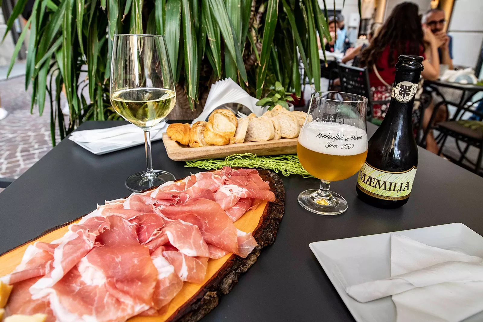 Two wooden planks full of cured meat and bread