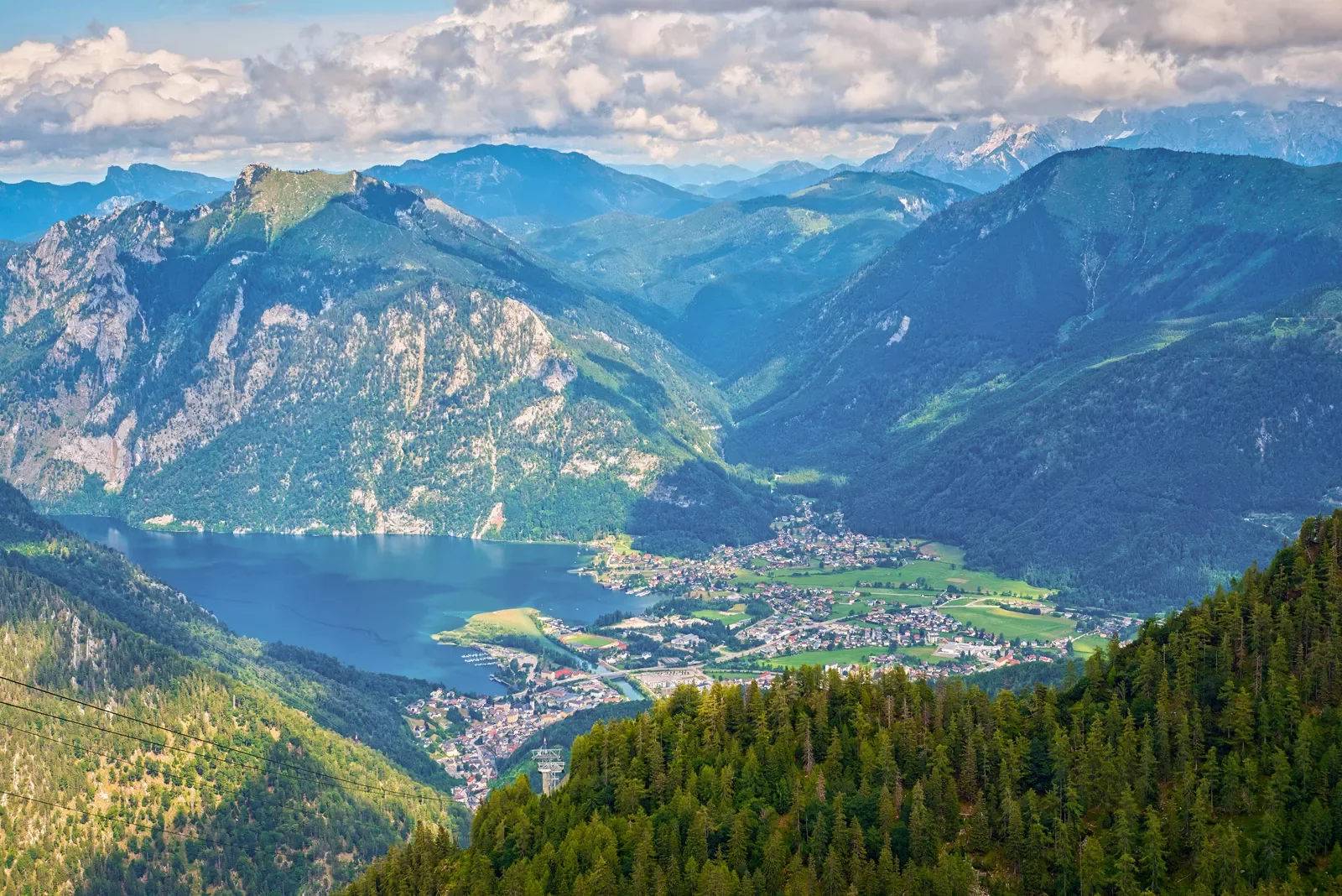 Mountainside shot of a forest and town in the distance