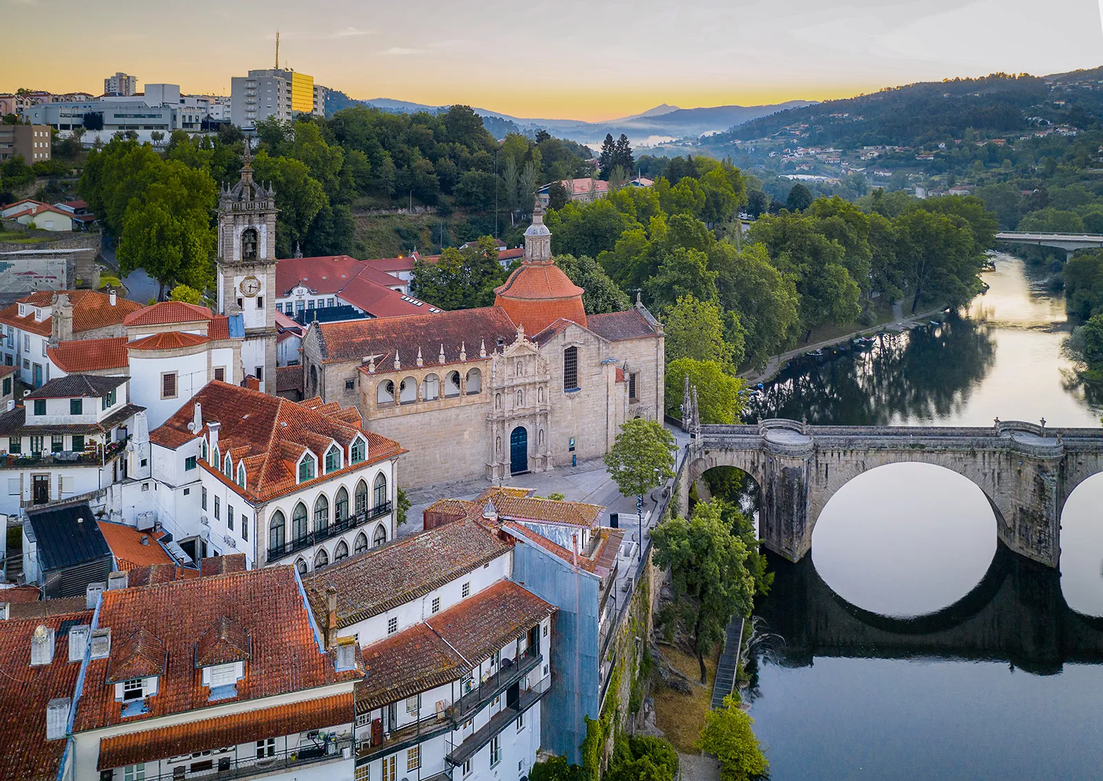 Ancient castle-like buildings with a bridge connecting to the town