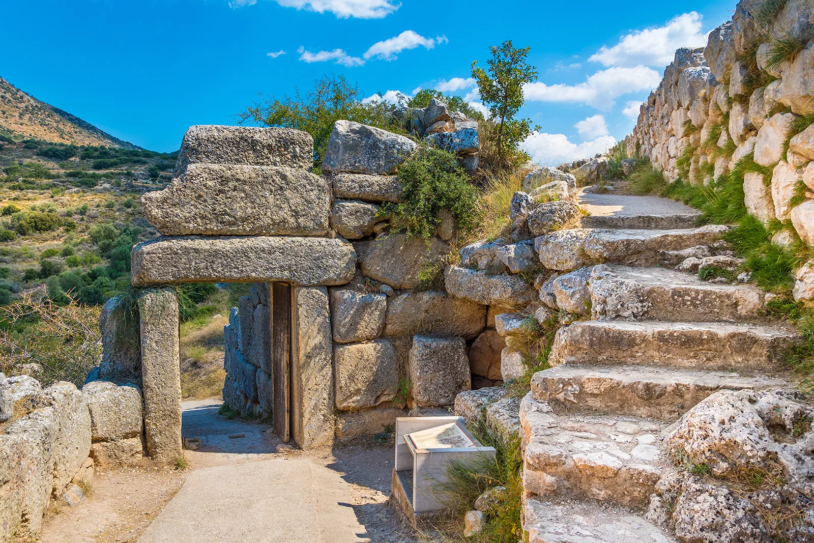 Rustic walkway with stone stairs and archways