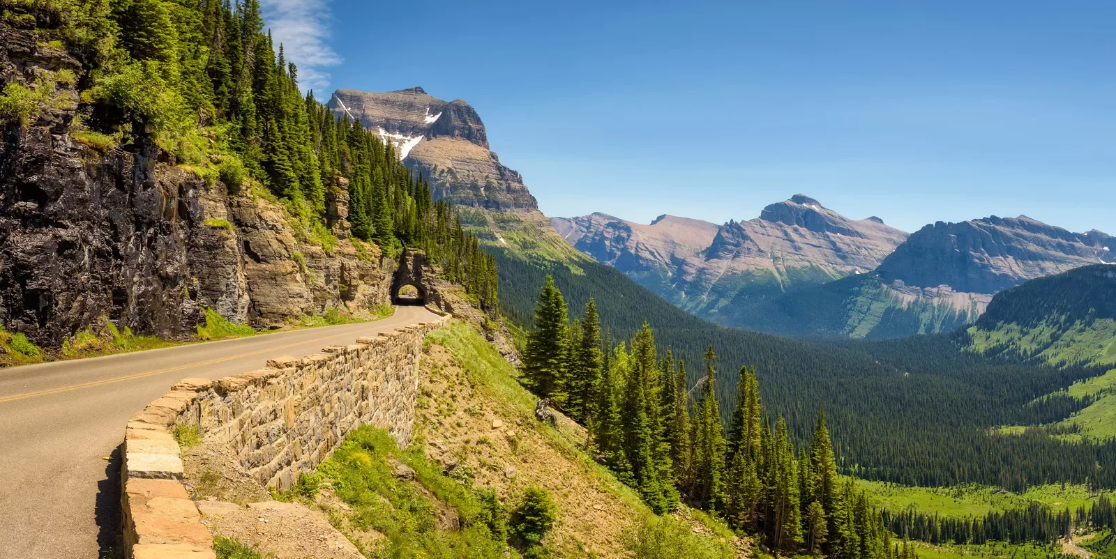 Long road along a cliff with trees in the distance