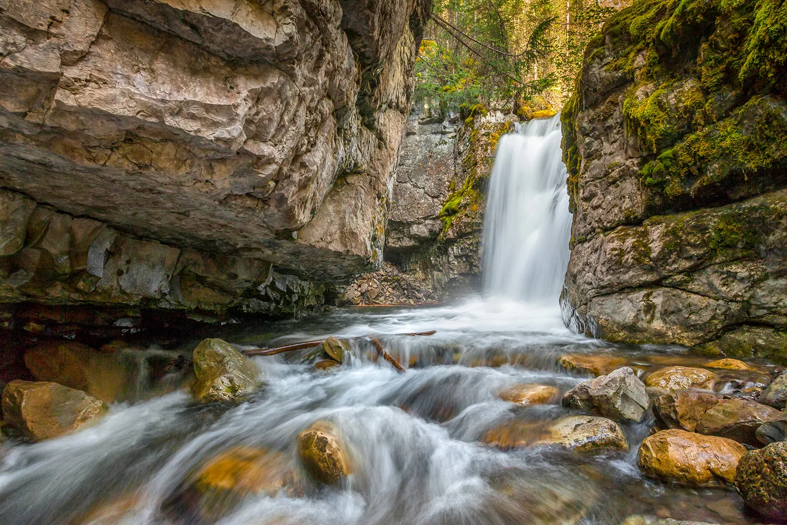 Small river with a waterfall in the background