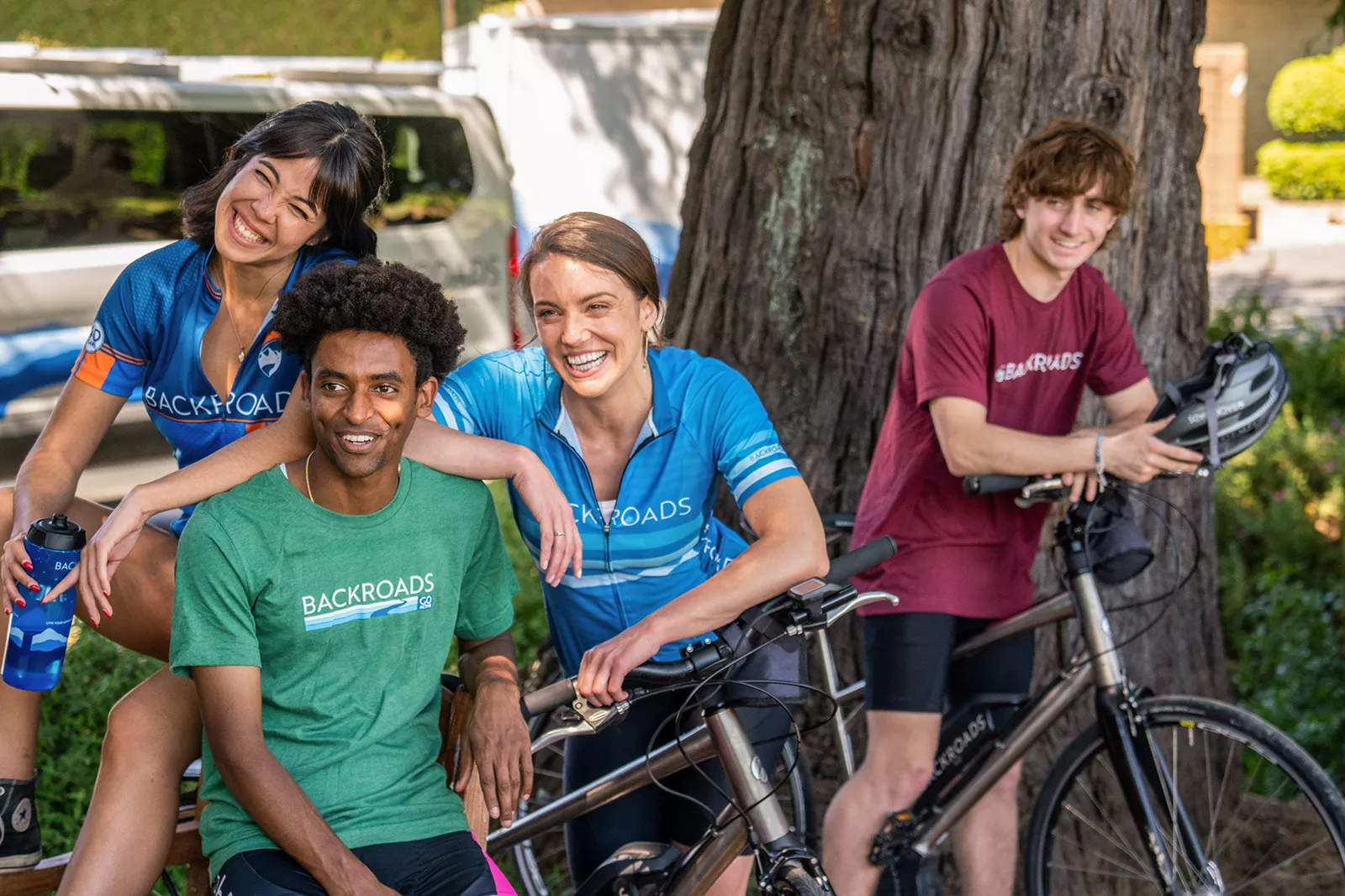 Two men and women standing arounf their bikes smiling