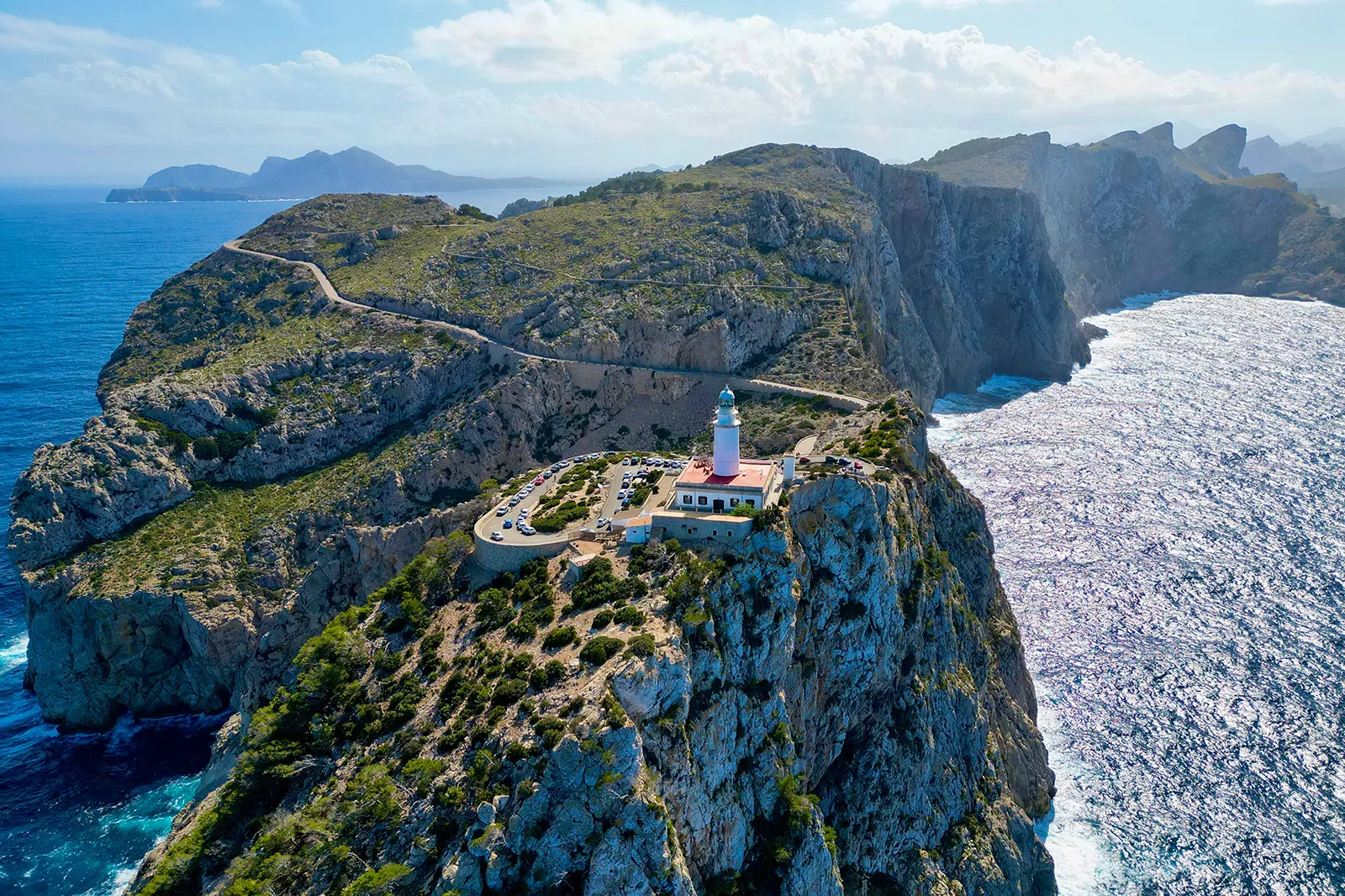 Building with a large pole at the top of a cliff