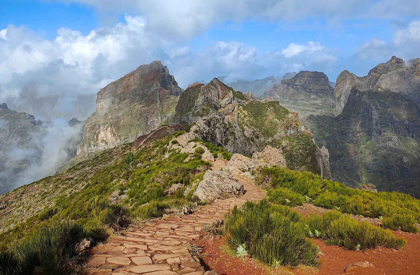 Stone pathway leading towards foggy mountains