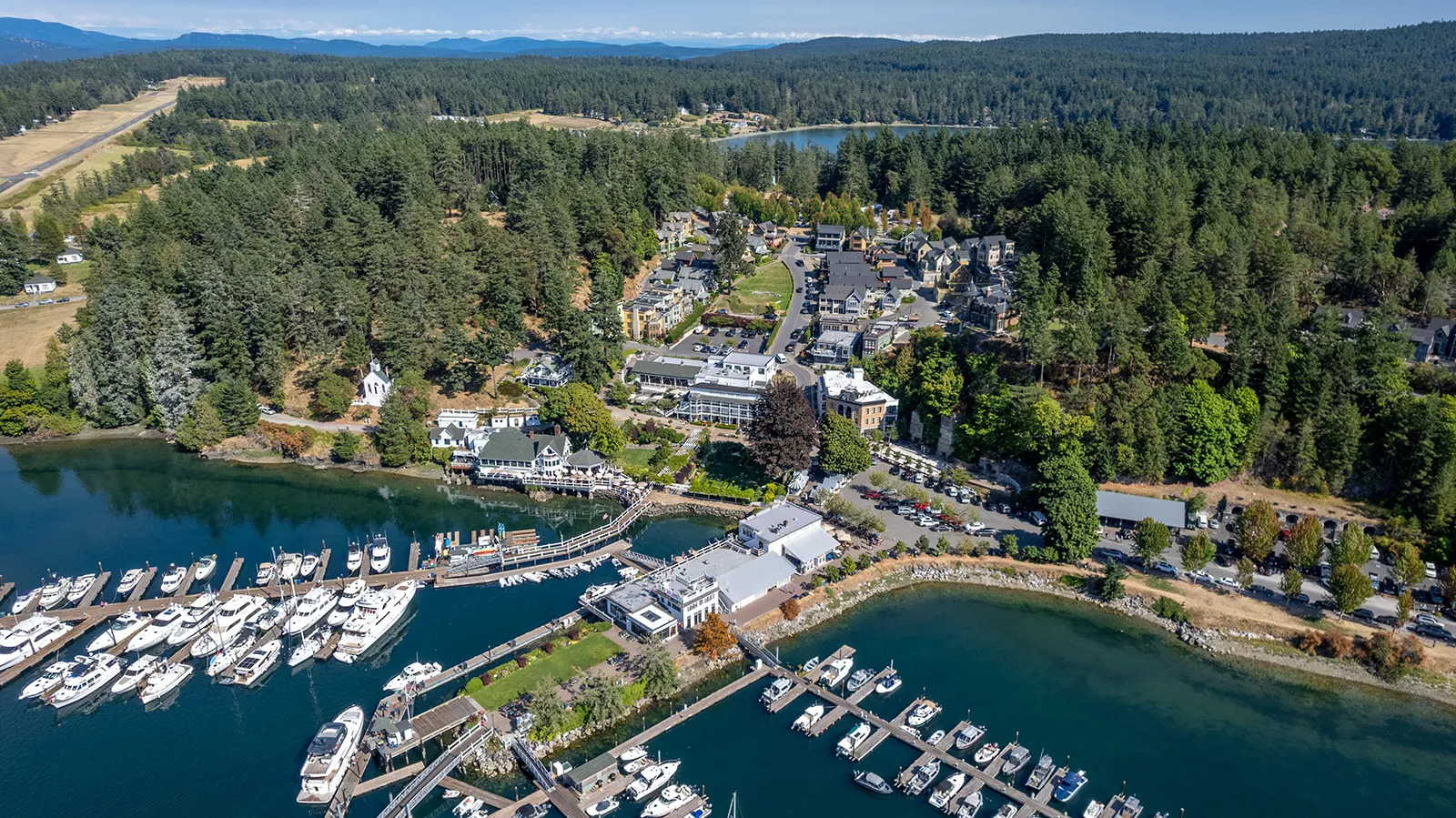 Sky view of a property complex with boats along a port