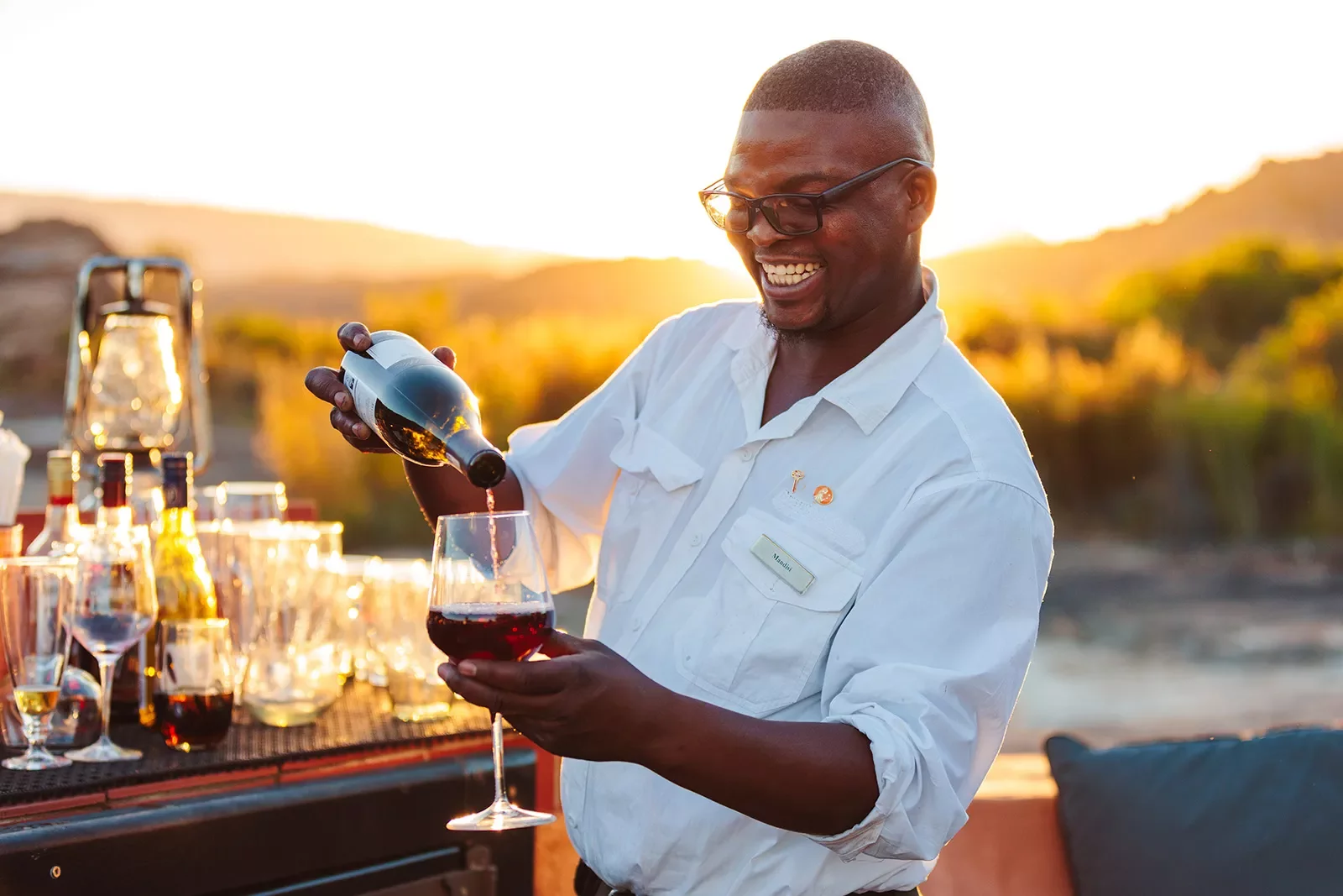 A man pours wine into a wine glass