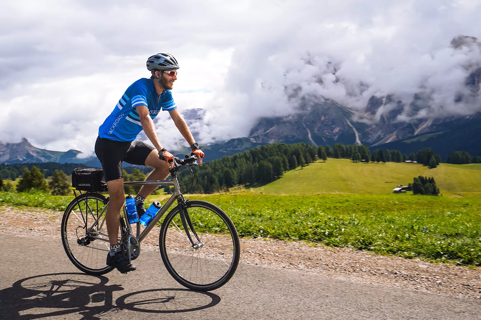 Man wearing sunglasses and riding a bike