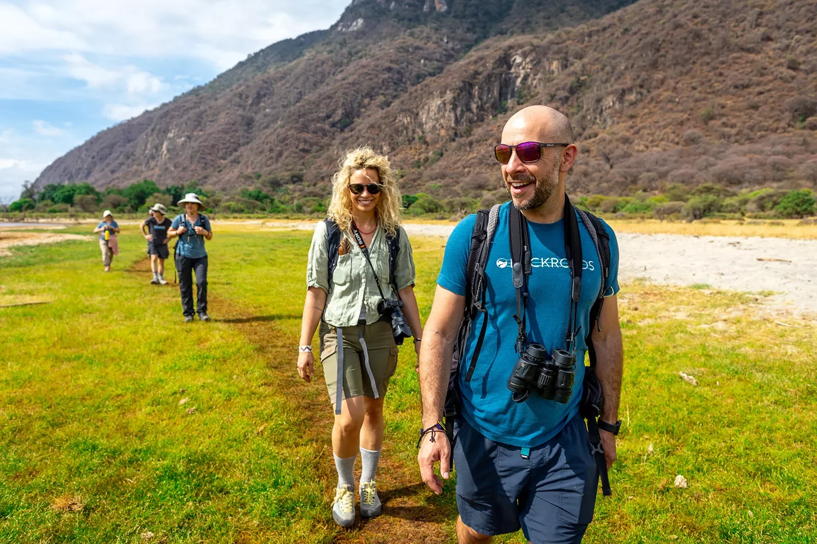 hikers crossing a grassy plain