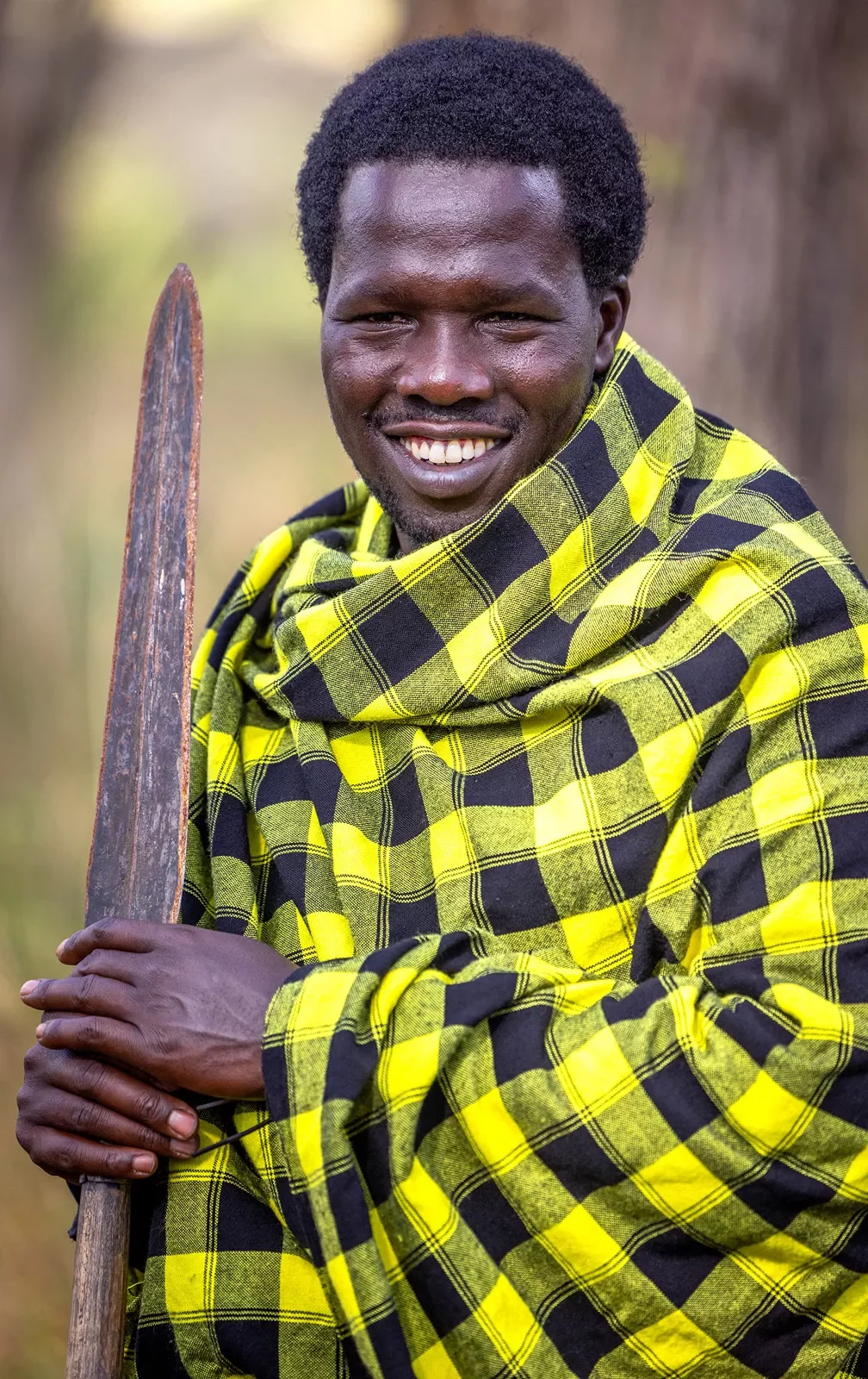 A man in a yellow coat smiling