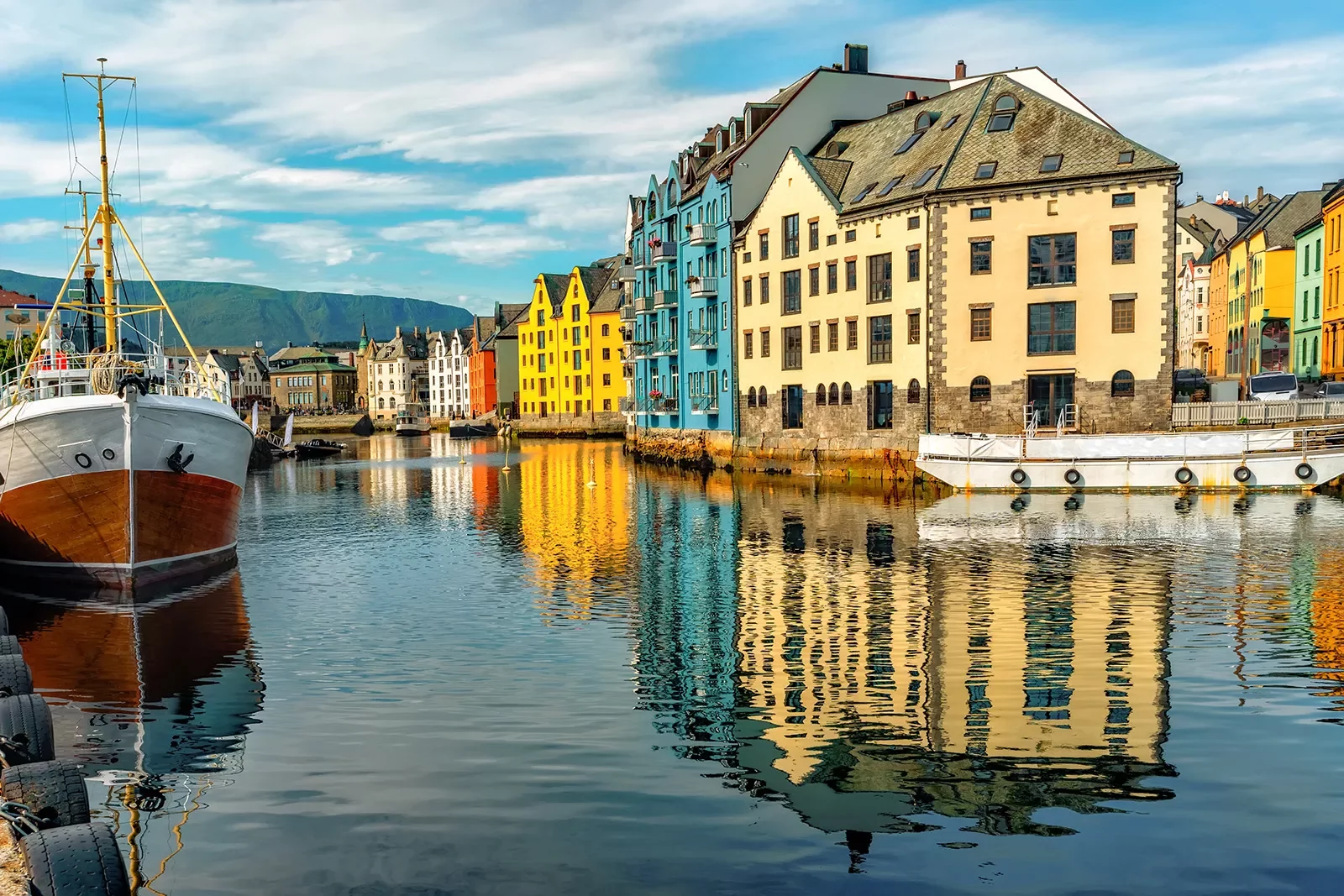 River in between tall houses in a town