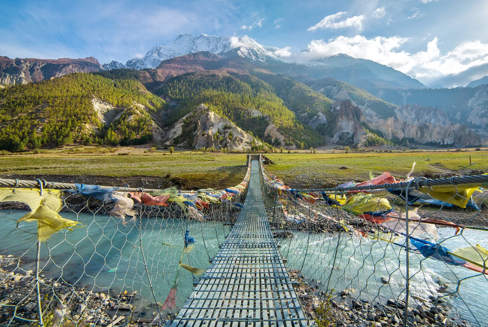 Metal bridge with color flags along the ropes