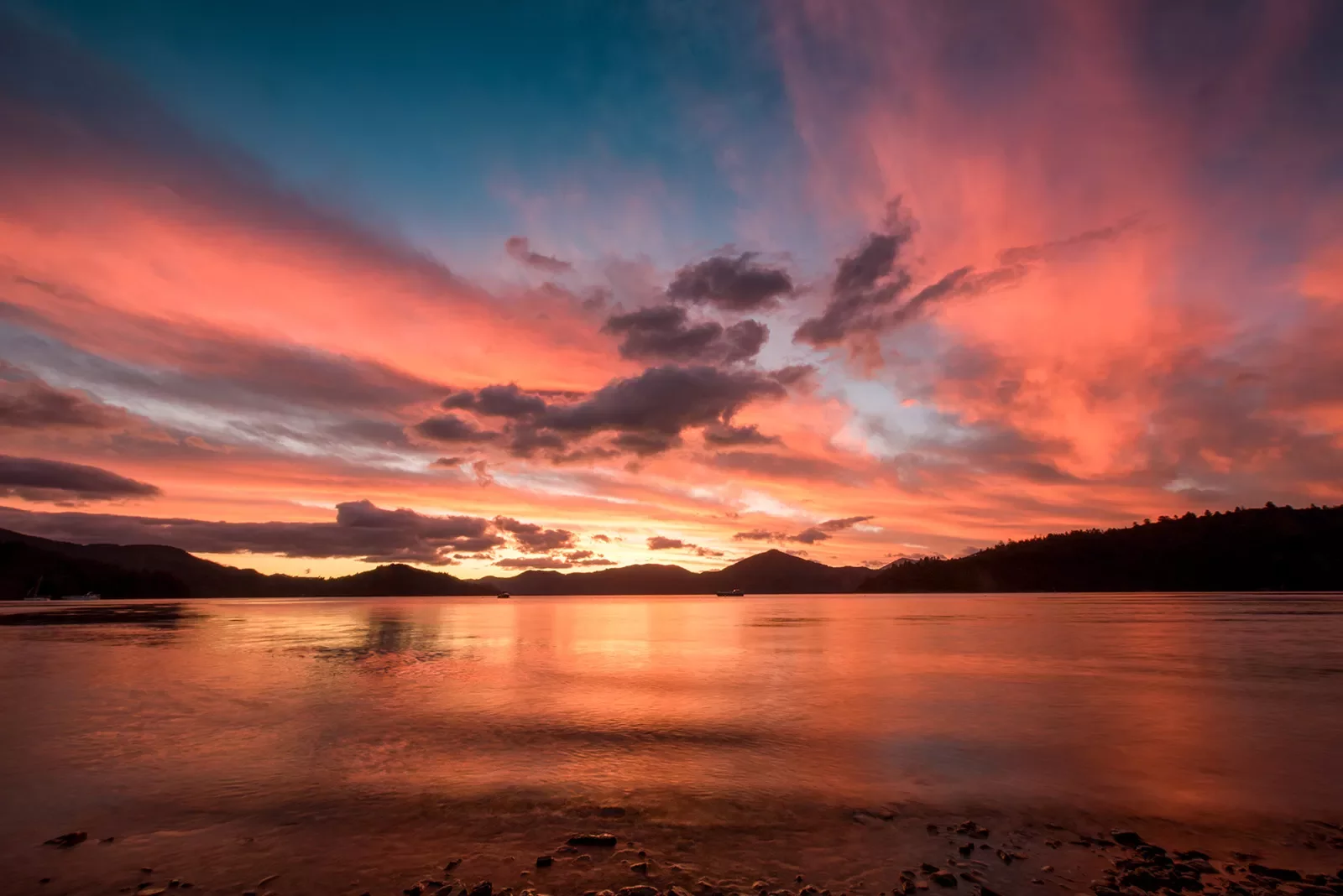 Sunset at the beach with purple and pink clouds