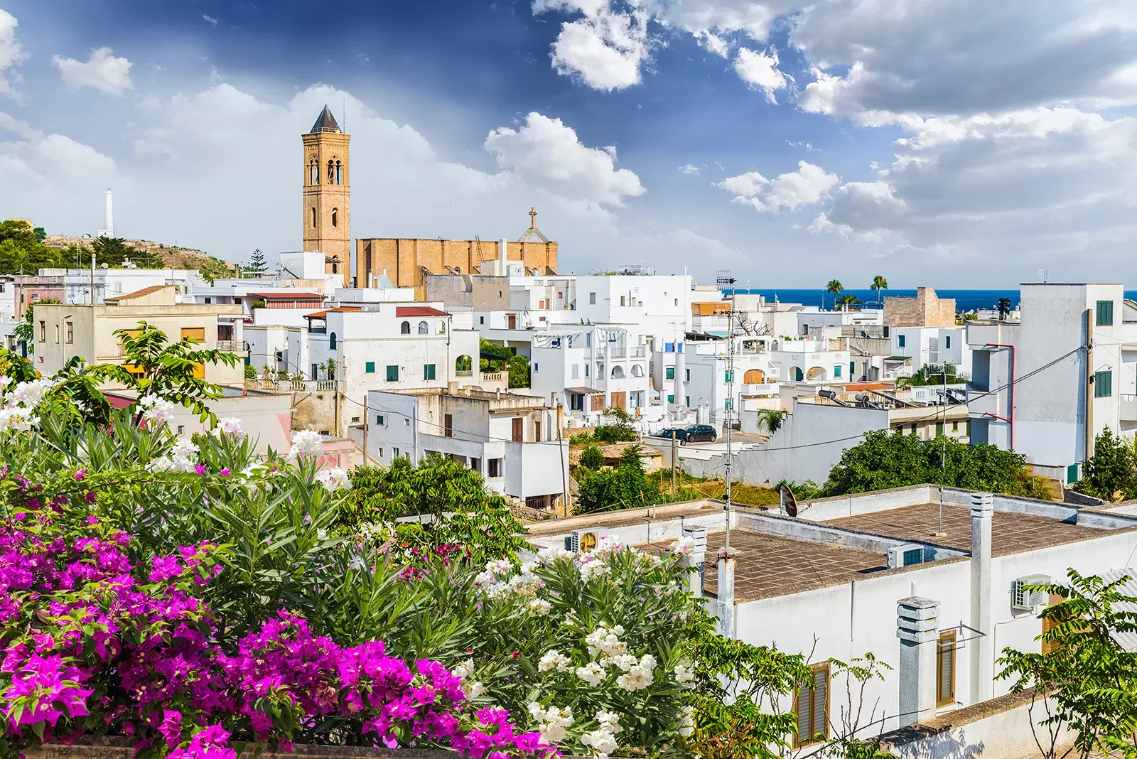 White buildings in the distance with an orange brick church building in the distance