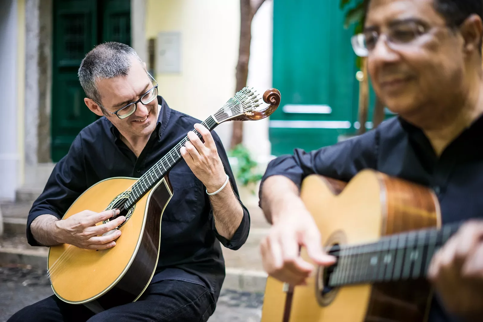 Two men playing guitars