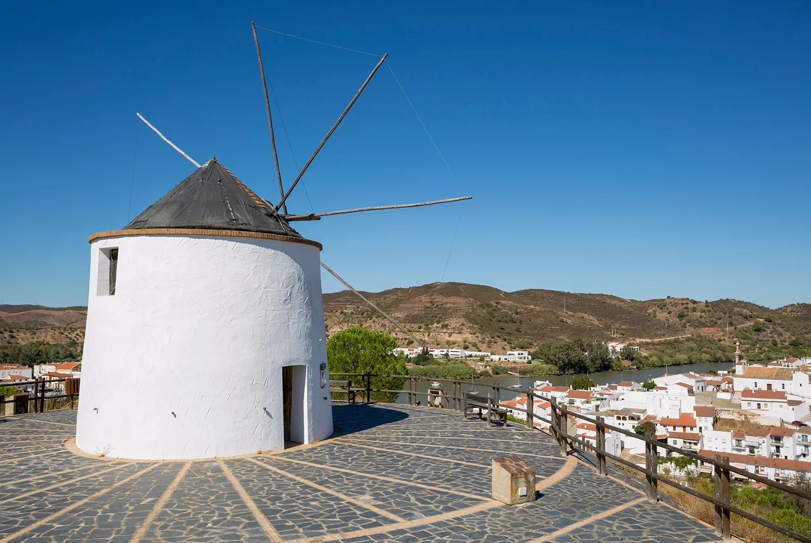 Rustic windmill tower overlooking a small town