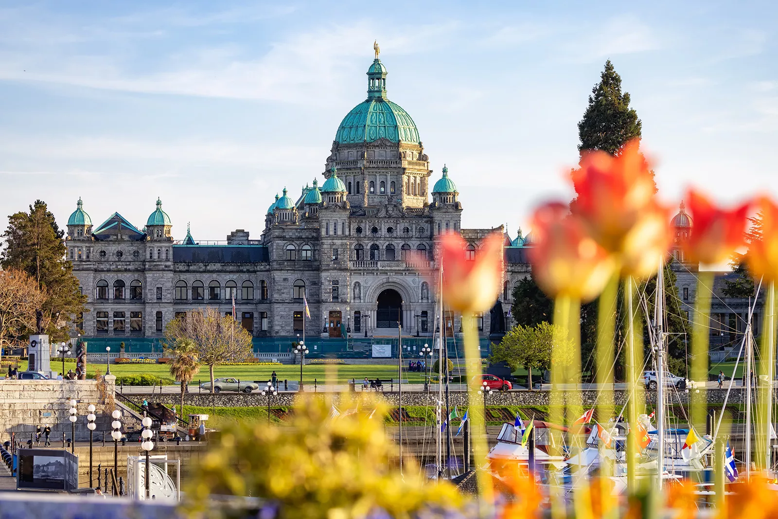 Wide exterior view of a castle-like building with tulip flowers close to the camera shot