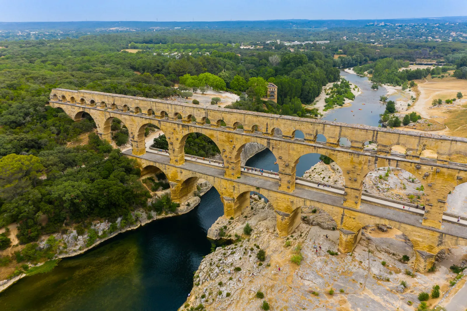 Rustic, stone bridge over a canyon and forest