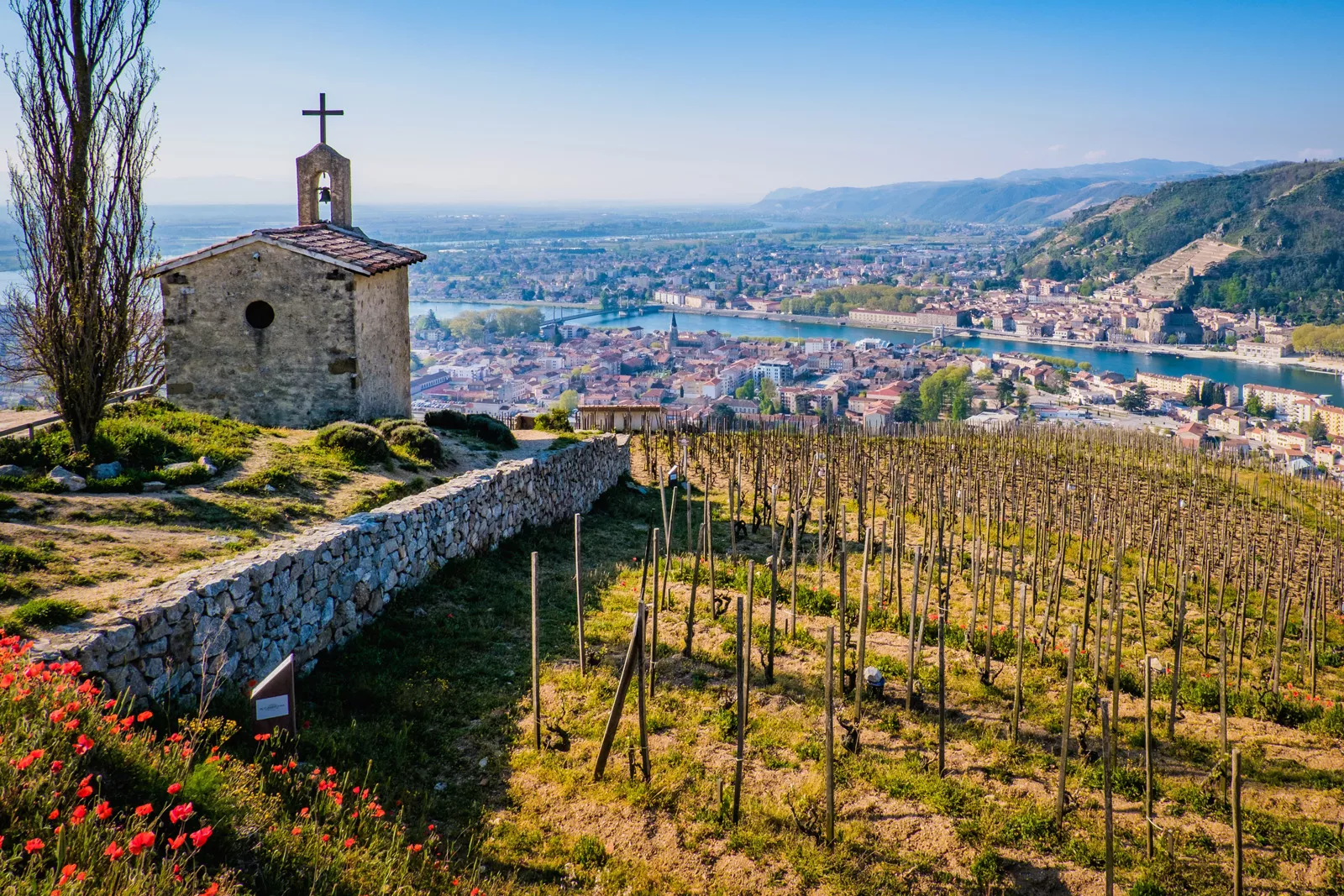 Church building on a hill looking down at a rustic town