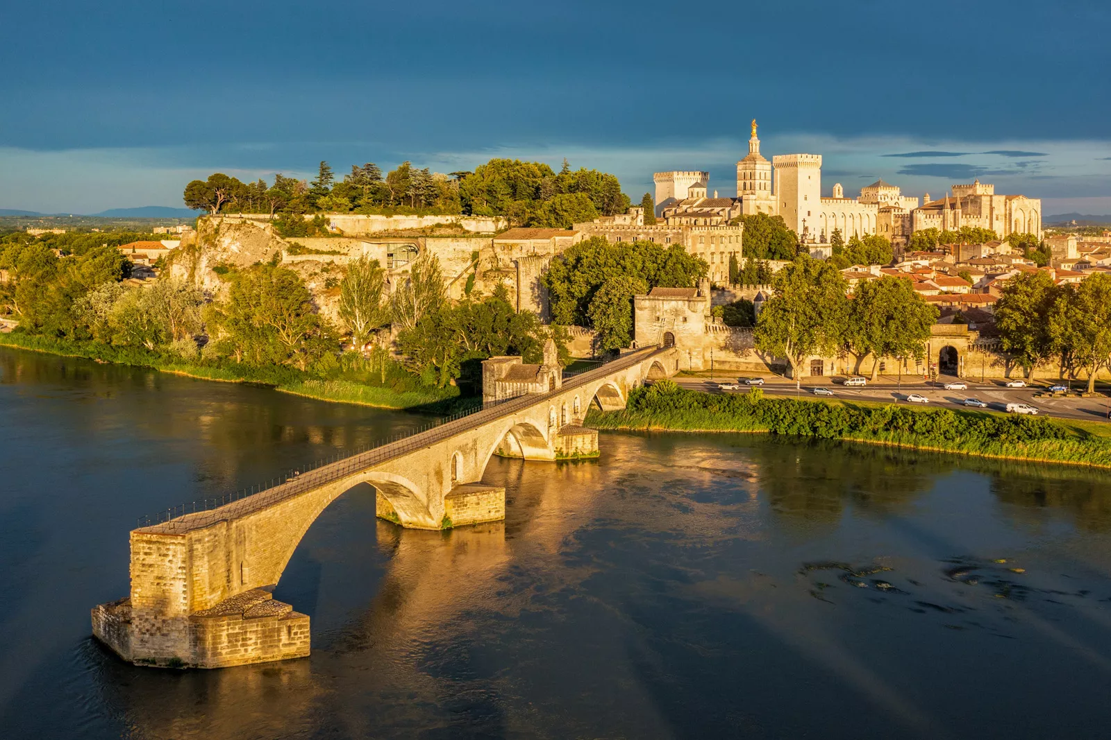 Bridge over a large body of water, connected to a rustic town