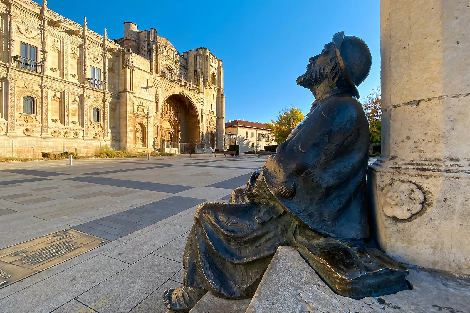 Bronze statue in an open courtyard in a rustic, Spanish center